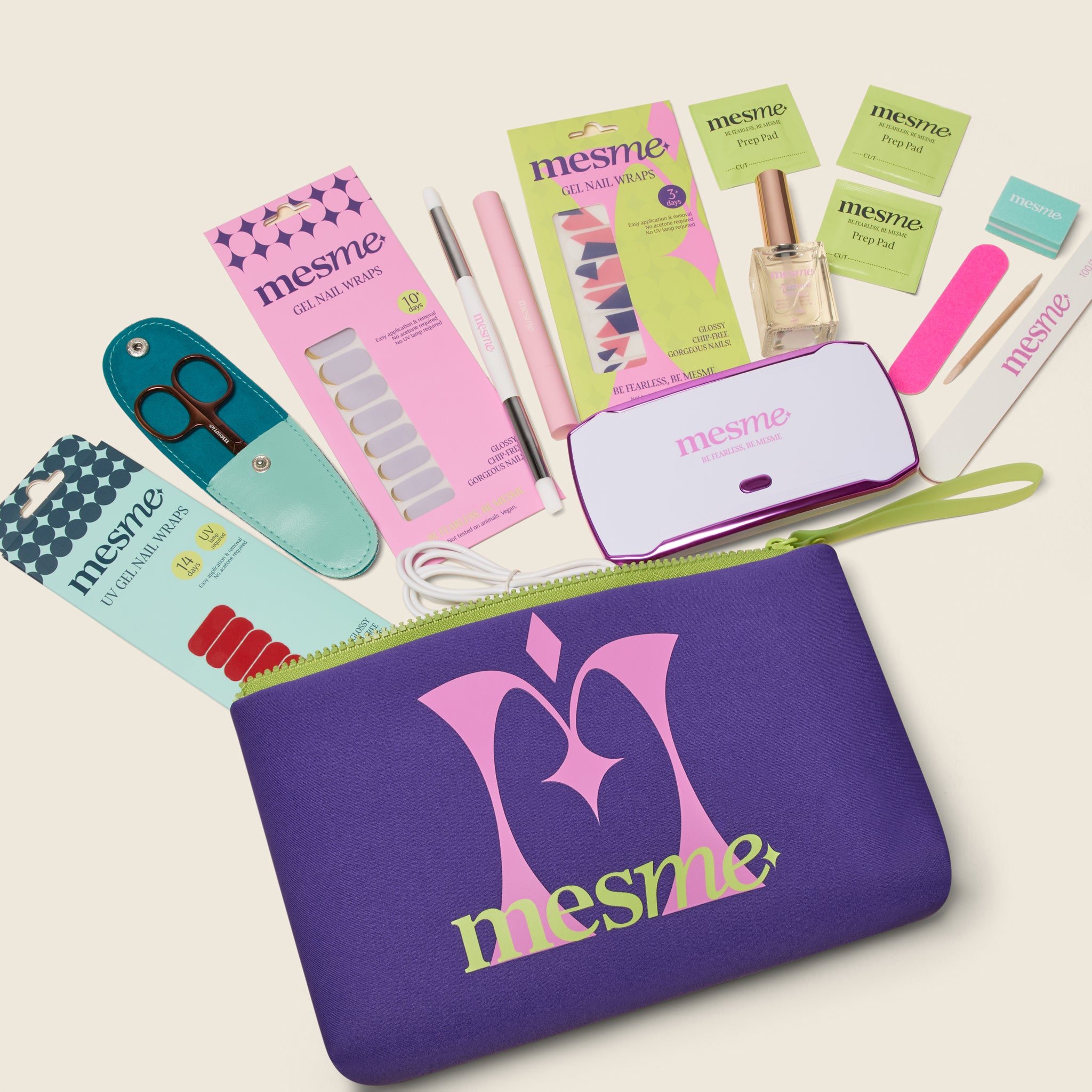 Collection of mesme Discovery Kit products including 3 different gel nail wraps, scissors, wrap remover pen, clear top coat, mini UV lamp and mini prep kit